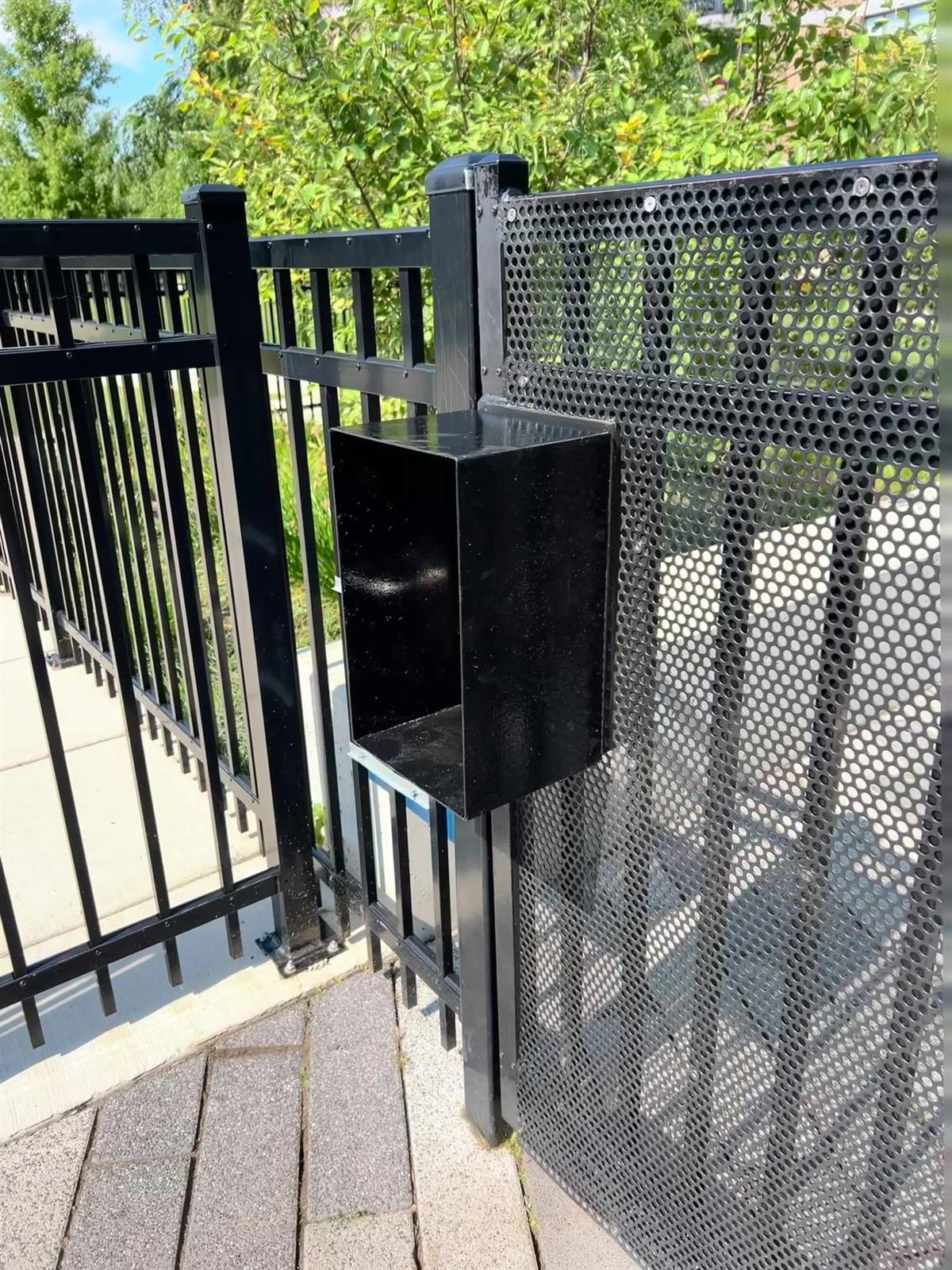 Ornamental steel fence with perforated privacy panel and custom welded steel box