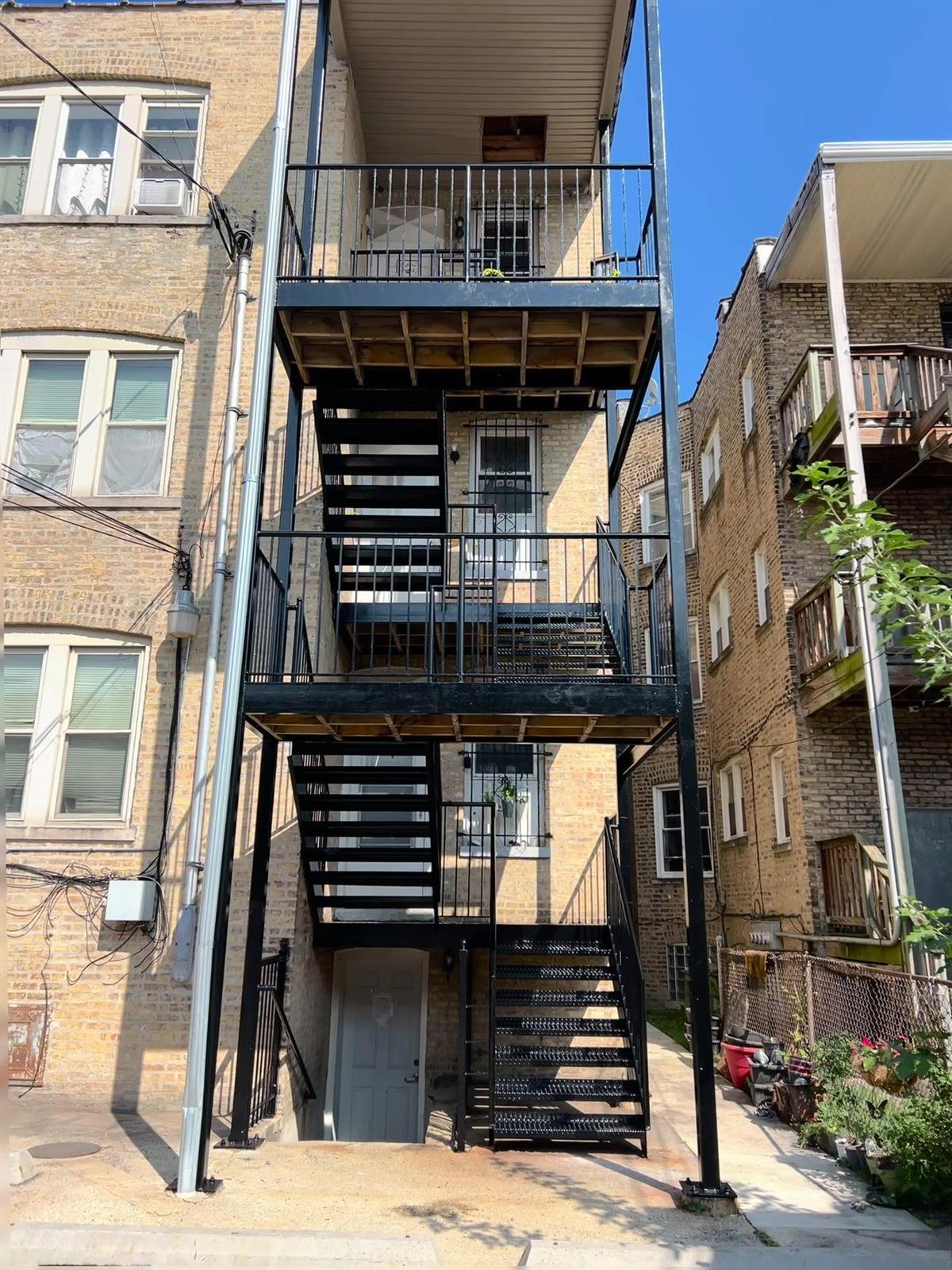 Three-story steel porch and stair system rebuilt on a Chicago brick apartment building