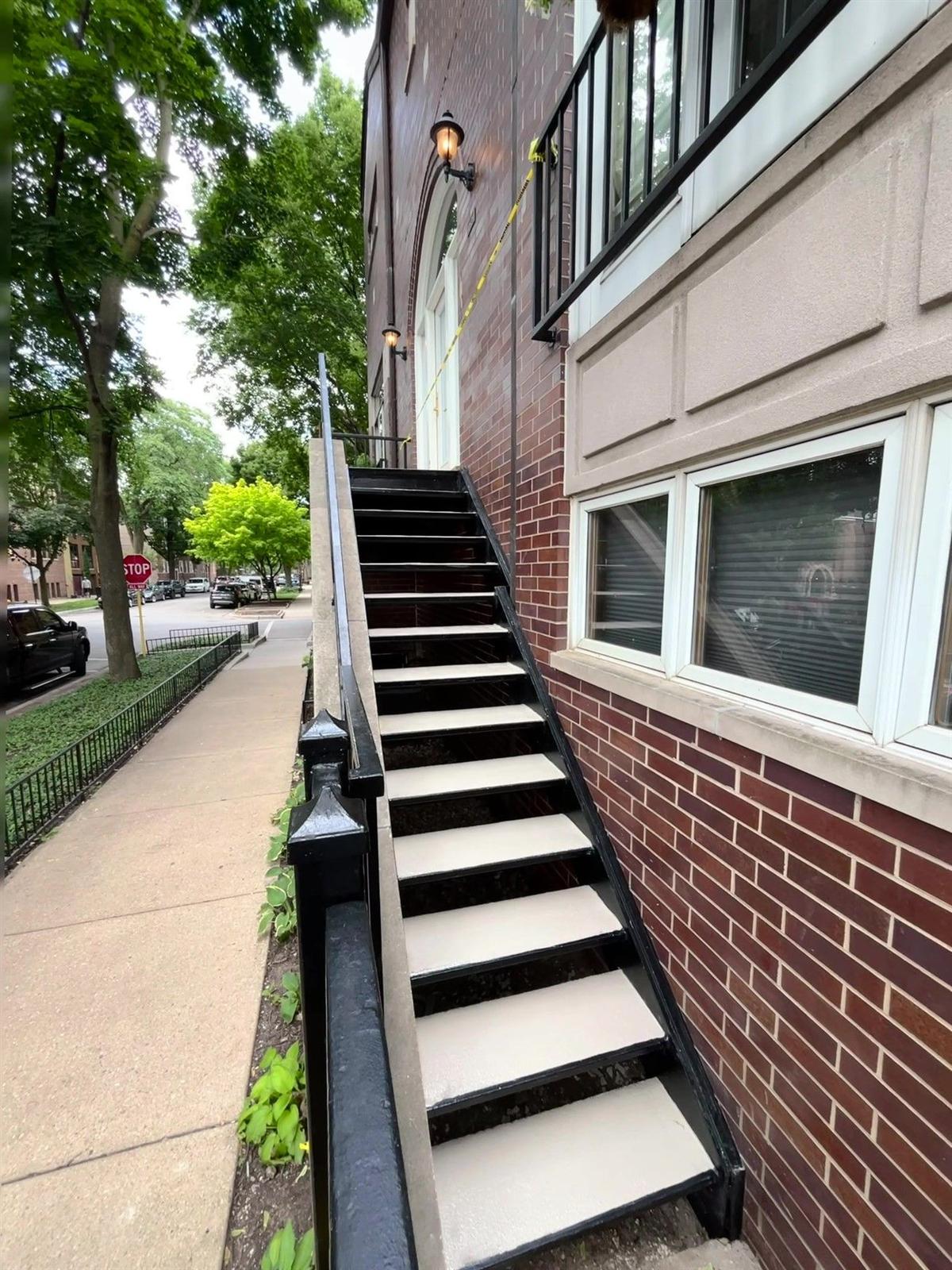 Steel staircase with contrasting treads installed along a Chicago brick building