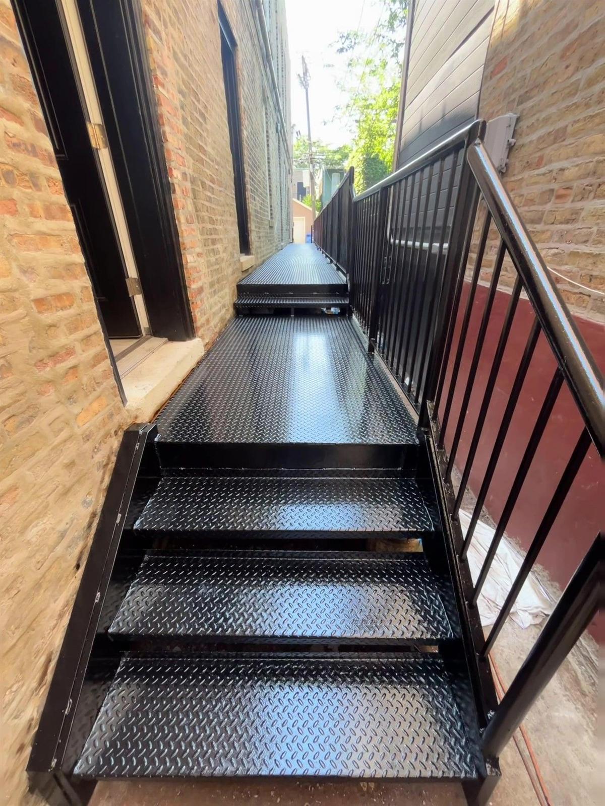 Steel walkway and stairs finished in fresh glossy black protective coating